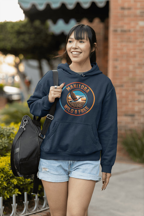 Celebrate the heart of the prairies with our Manitoba – Wild & Free hoodie, featuring a stunning graphic of a Canadian goose soaring over golden wheat fields.